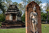 Thailand, Old Sukhothai - Wat Traphang Ngoen, smaller chedi with statue of walking Buddha. 